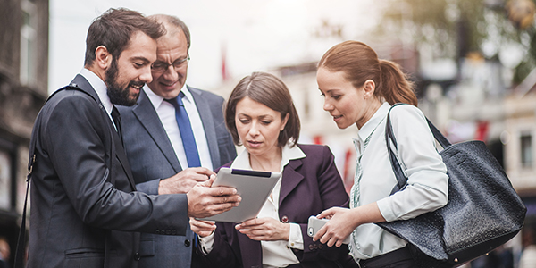 Business people having a discussion, walking down the street,600x300