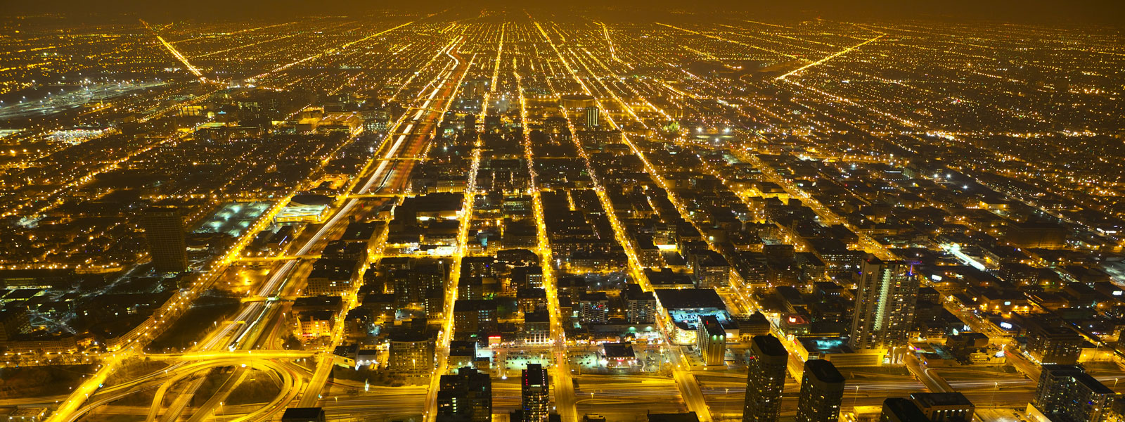 a birds eye view of a large city lit up with lights at night