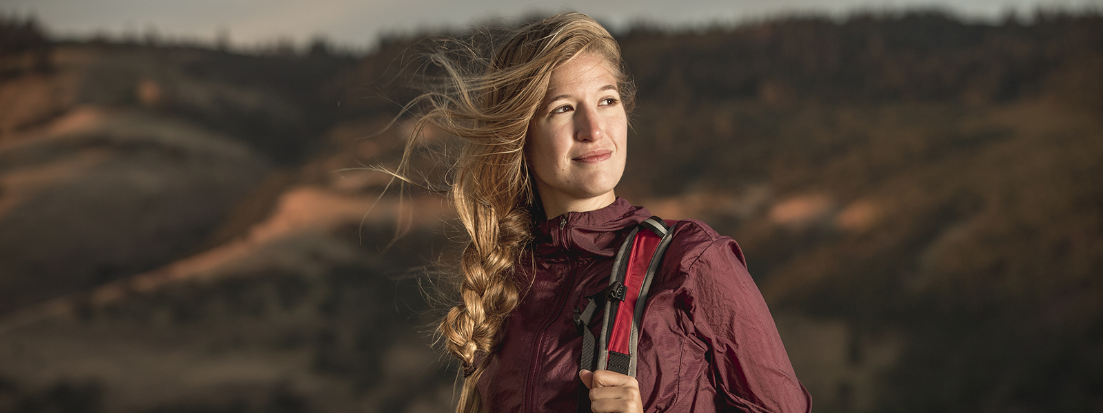 A young female hiker up early, looking optimistic.
