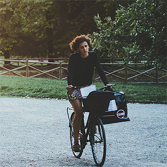 Woman on a bike ride through the park.
