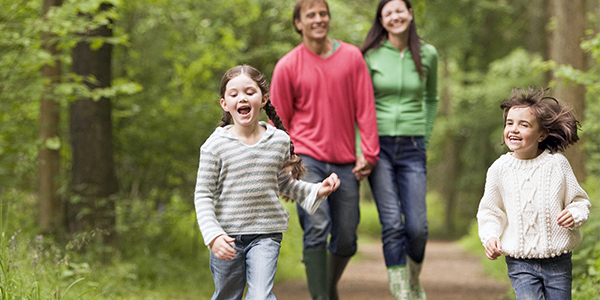 Family enjoying a walk through a wooded path