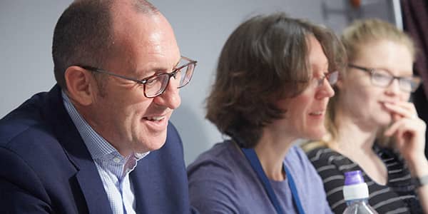 A man and two women having a meeting