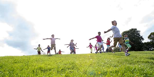 Group of children running down the hill