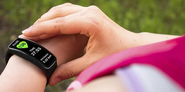 Woman checking her pulse rate using a smart watch