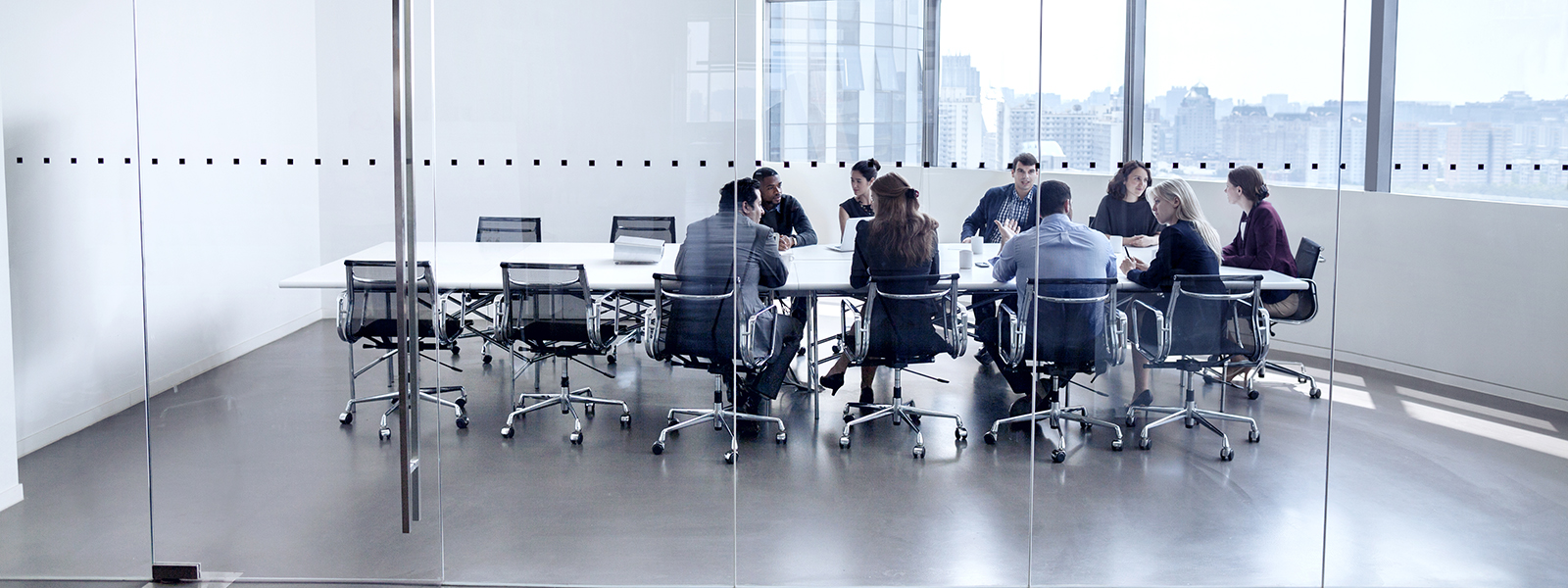 Colleagues at business meeting in conference room.