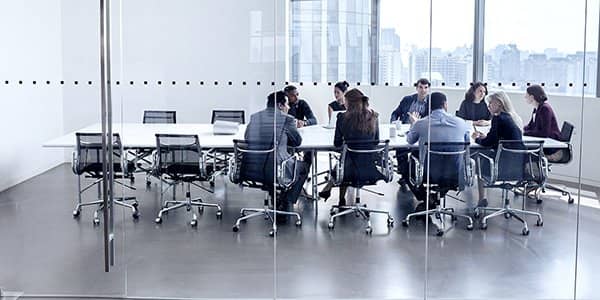 Colleagues at business meeting in conference room.