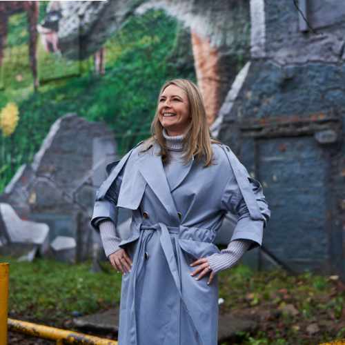 Dr Clare Daly in front of mural