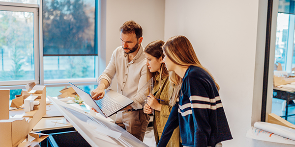 Lecturer working with students on a project