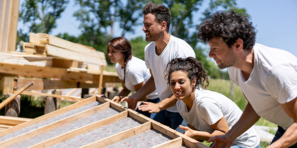 Group of students helping build a house