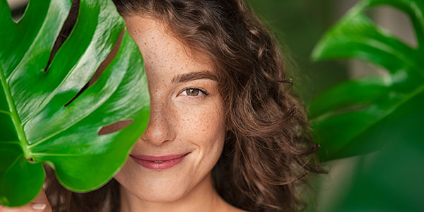 Woman's face behind a leaf 