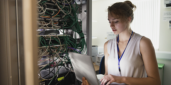 Female technician checks server