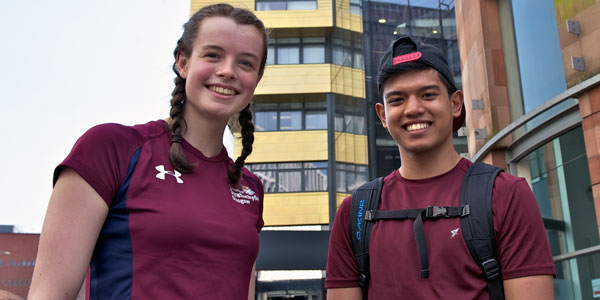 a male and female student smiling at the camera