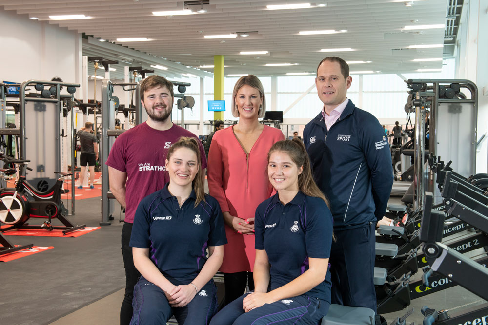 Sirens players Bethan and Niamh smile at the camera with Strathclyde Sport staff