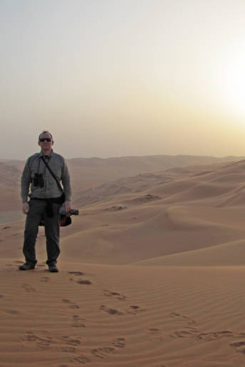 The author of the photo is standing on the Rub’ al-Khali desert.