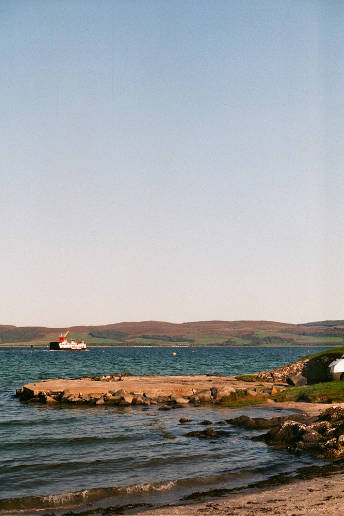 View of the Kintyre peninsula with ferry going across.