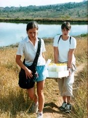 Students collect water samepls during fieldwork