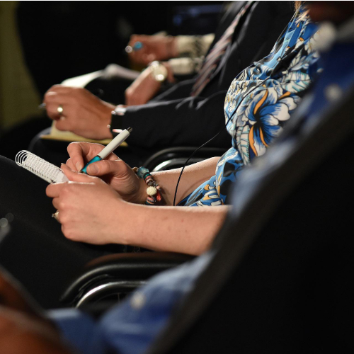 people seated and taking notes