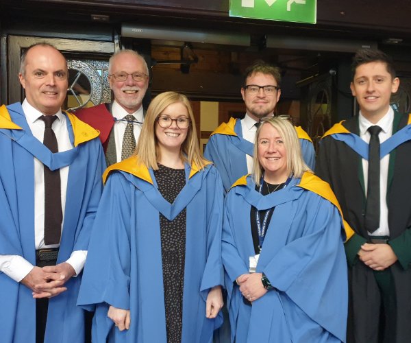 Group of lecturers in academic robes attending graduation