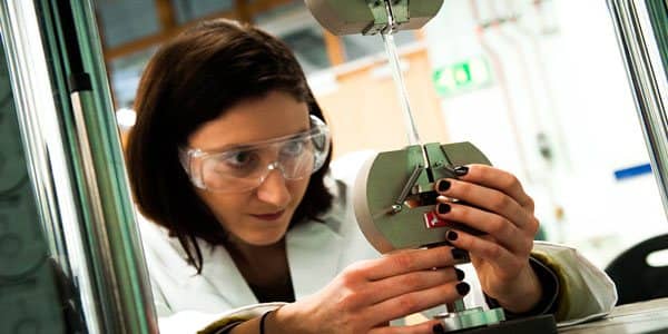 engineer works on a piece of equipment in a lab