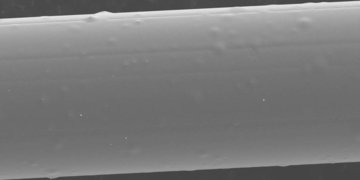 SEM image of surface of an APS-coated glass fibre after heat treatment at 300°C