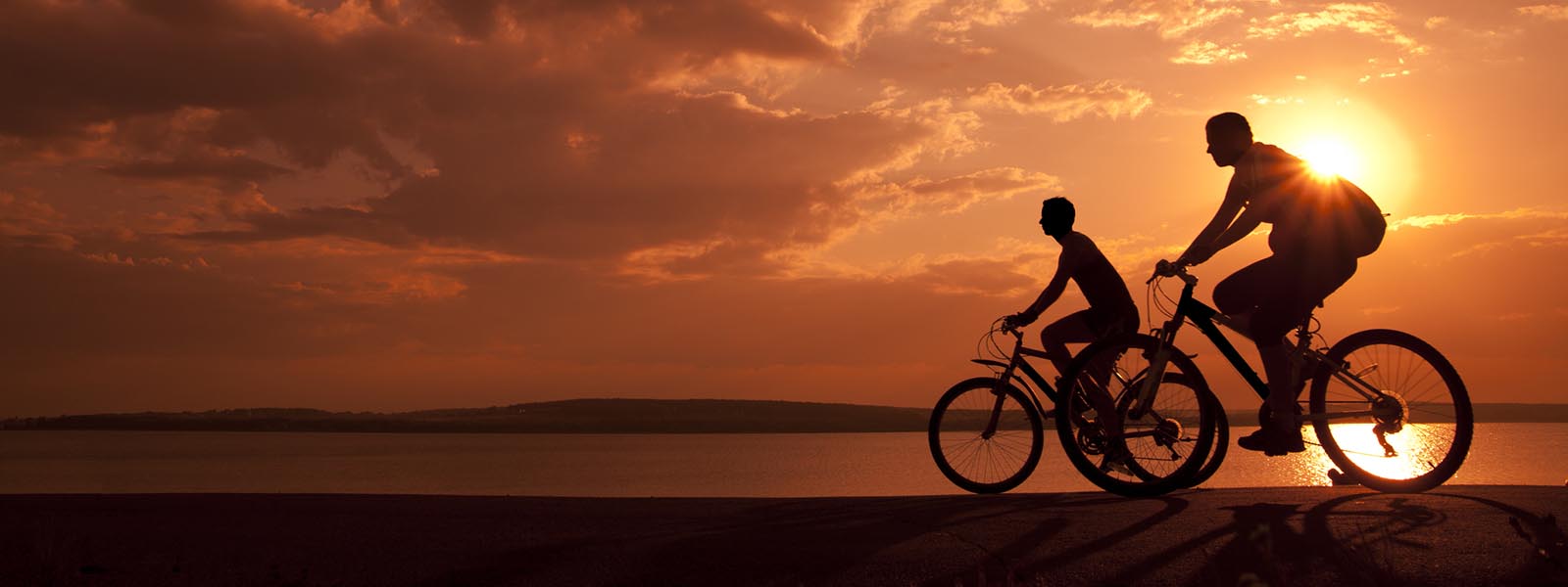 Couple cycling at sunset