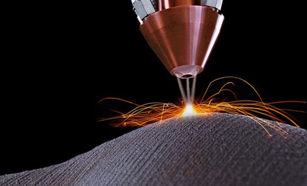 Closeup of a laser welding machine with sparks