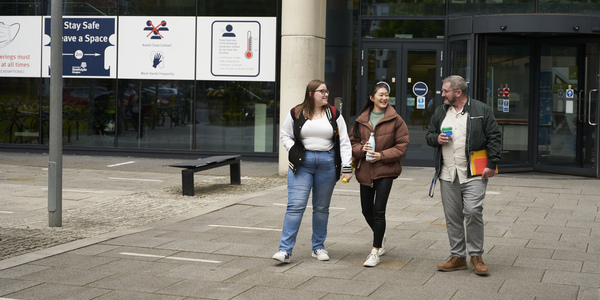 Group of students walking on campus.