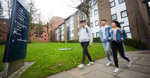 Three students walking on campus