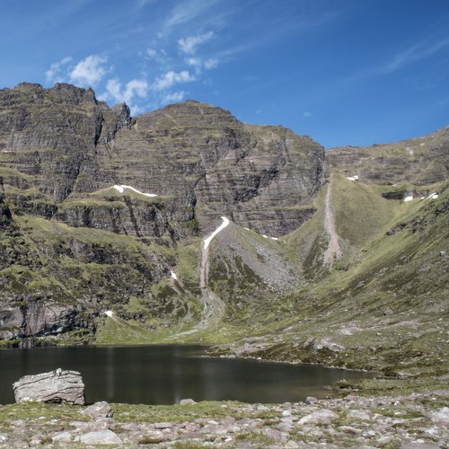 Blue sky over a mountain and loch