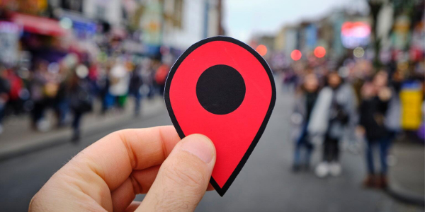 Person holding a location pin marker