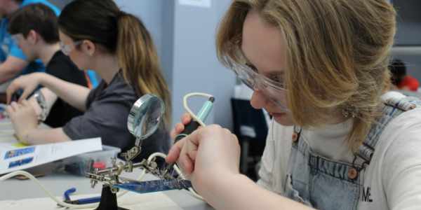 A EEE Participant soldering in the lab