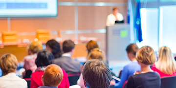 Delegates listening to speaker at seminar 