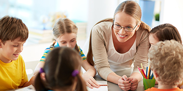 Teacher in discussion with children