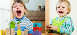 Two children playing with blocks 